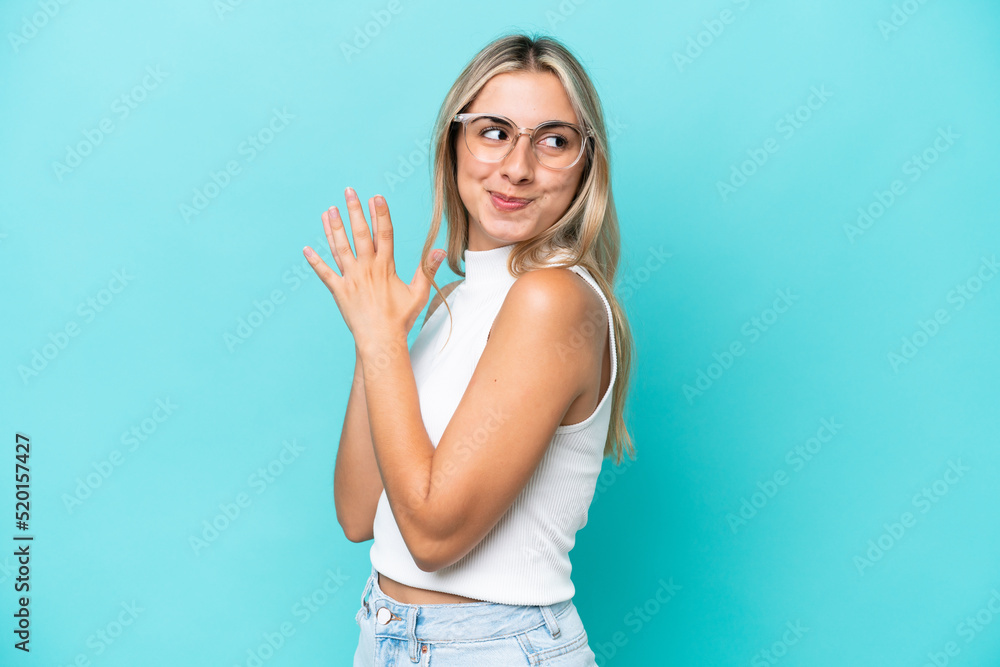 Young caucasian woman isolated on blue background scheming something
