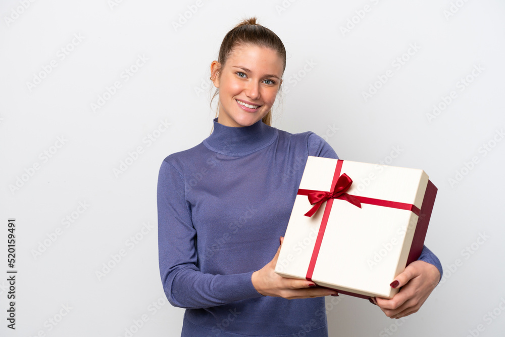 Young caucasian woman holding a gift isolated on white background with happy expression Young caucasian woman holding a gift isolated on white background with happy expression