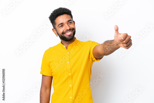 Young Brazilian man isolated on white background giving a thumbs up gesture