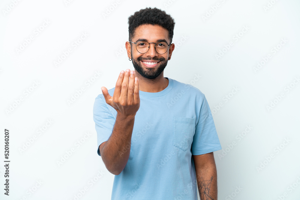 Young Brazilian man isolated on white background inviting to come with hand. Happy that you came Young Brazilian man isolated on white background inviting to come with hand. Happy that you came