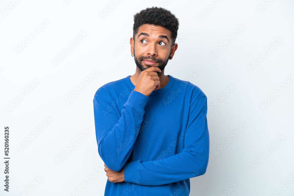 Young Brazilian man isolated on white background thinking an idea while looking up Young Brazilian man isolated on white background thinking an idea while looking up