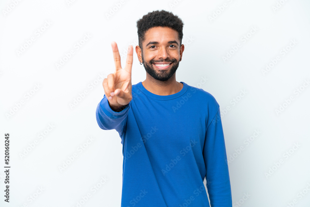 Young Brazilian man isolated on white background smiling and showing victory sign Young Brazilian man isolated on white background smiling and showing victory sign