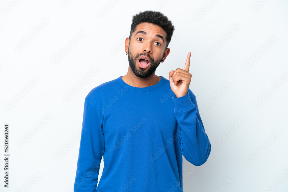 Young Brazilian man isolated on white background intending to realizes the solution while lifting a finger up Young Brazilian man isolated on white background intending to realizes the solution while lifting a finger up