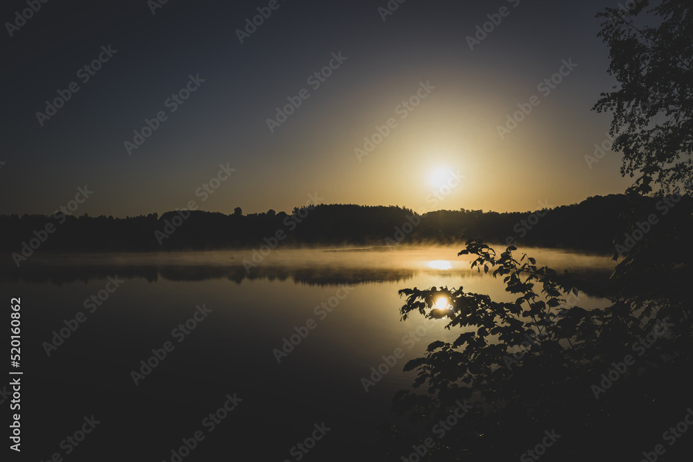 Fototapeta premium fog over the forest lake at sunrise