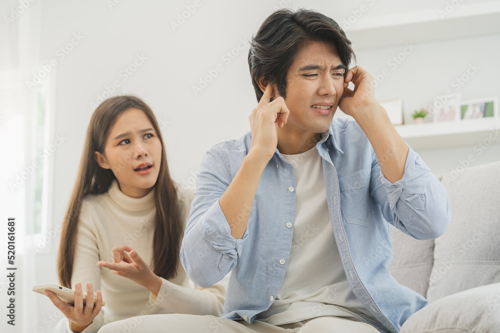 Φωτογραφία Infidelity, suspicion asian young couple love fight relationship, husband put hand on his ears, no want to hear
