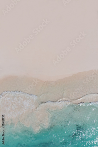 Beach top view, beautiful seashore, sand and blue waves. drone shooting, natural background. Copy the space on the sand, free space for your design