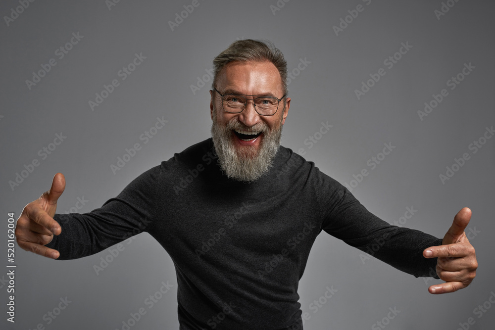 Senior cheerful caucasian man with rock gesture Senior cheerful caucasian man with rock gesture