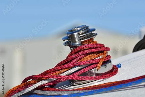 Details of winch and ropes on sailing boat racer. Boating concept. Blurred background . Horizontal view 