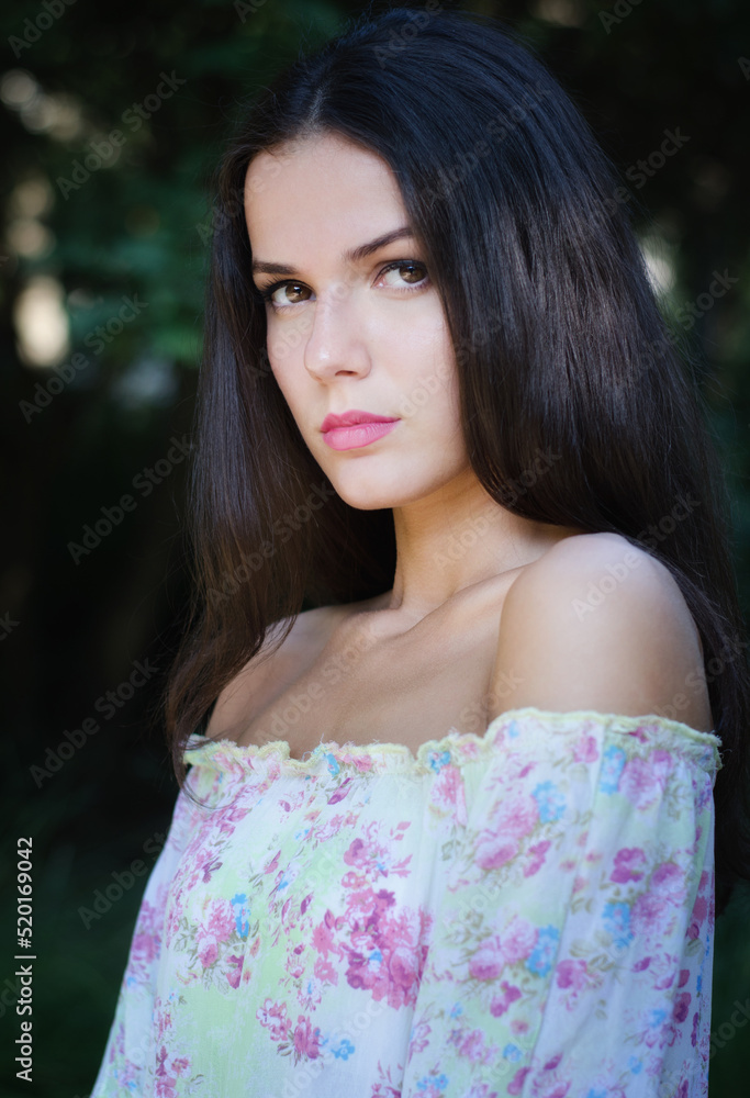 Naklejka premium Portrait of beautful girl outdoor in nature on sunny summer day