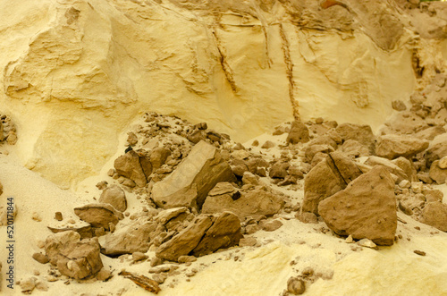 Weathered sand sculptures or formations with brown rock or earth stones. Sand is a loose sedimentary rock, as well as an artificial material consisting of rock grains.