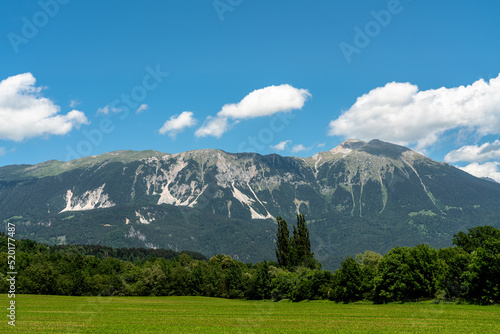 Beautiful panorama view of Veliki Stol (Hochstuhl) massif at border between Slovenia and Austria on a sunny summer day from Bled with blue sky cloud.