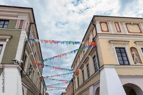 Photography A colorful garland against the background of a beautiful historic, renaissance tenement house