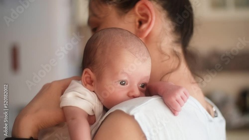 mother burping her newborn baby