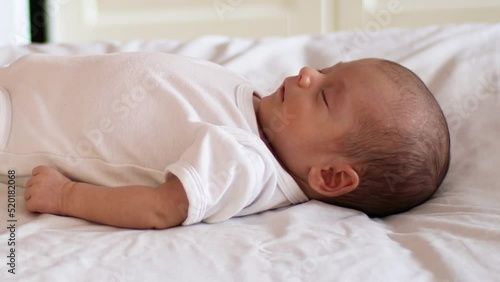 newborn baby on his back in light sleep - periodic (irregular) breathing pattern