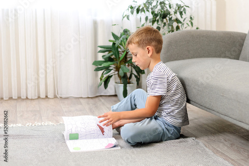 boy sitting on the floor with a book
