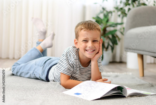 boy lying on the floor with a book