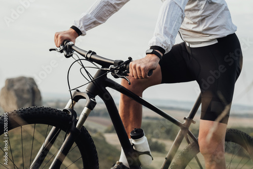 Cropped Unrecognizable Professional Male Cyclist Sitting on His Bike Outdoors, Sportsman Riding on Trail Track