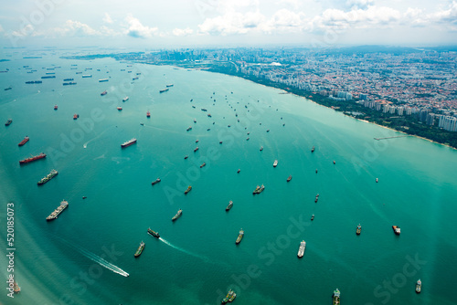  Aerial view from the plane window of the Singapore Harbor which has many ships waiting for loading and unloading.