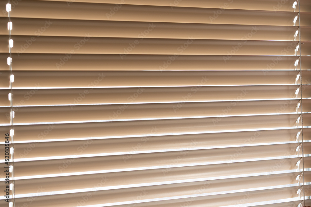 Blinds on the window. Light passing through the blinds Blinds on the window. Light passing through the blinds