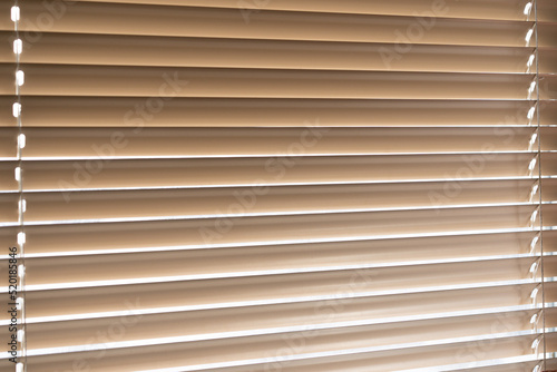 Blinds on the window. Light passing through the blinds