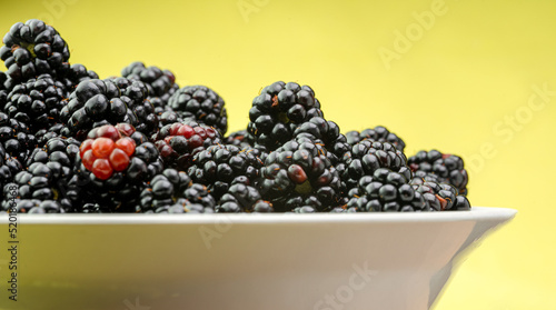 Ripe blackberries are in a plate