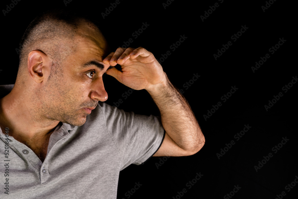 Man looking into the distance with his hand on his head Man looking into the distance with his hand on his head
