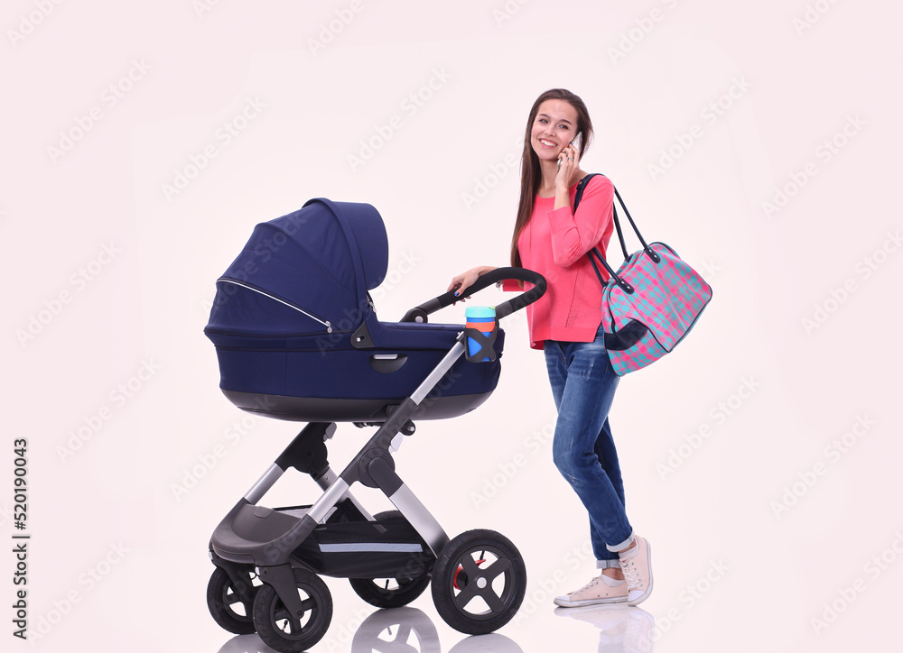 Full length portrait of a mother with a stroller, isolated on white background. Young mom Full length portrait of a mother with a stroller, isolated on white background. Young mom