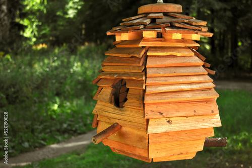 wooden birdhouse in the green park	