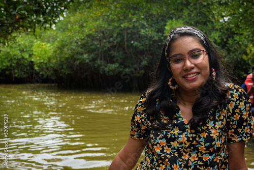 Young Indian woman boating through Pichavaram Mangrove Forests. The second largest Mangrove forest in the world, located near Chidambaram in Cuddalore District, Tamil Nadu, India photo