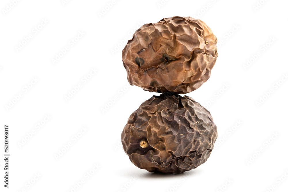 Two expired dried and spoiled passion fruits isolated on white background. Two expired dried and spoiled passion fruits isolated on white background.