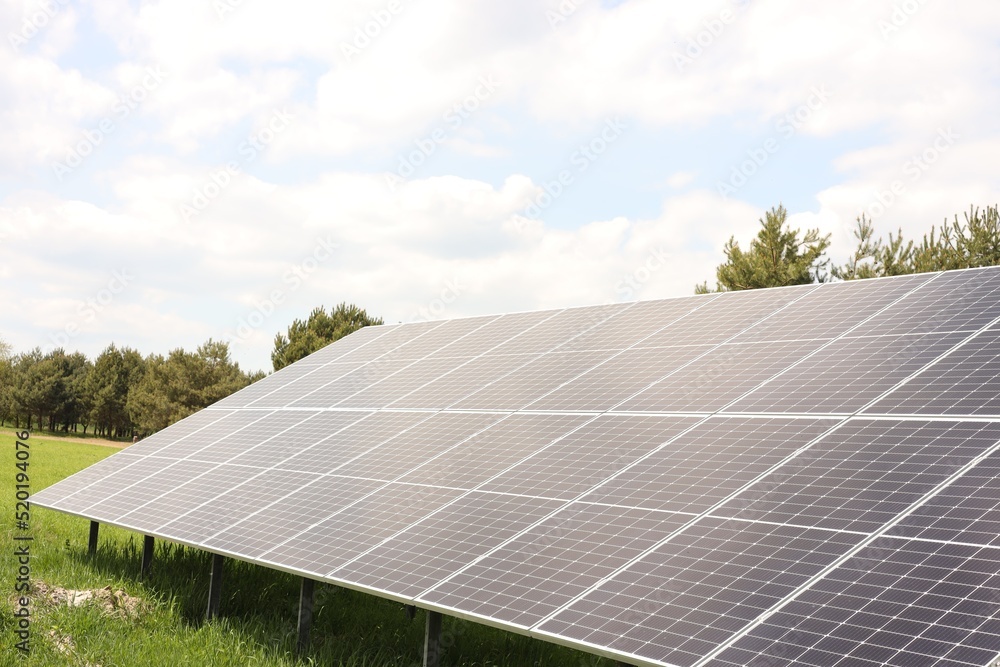 Solar panels in field on sunny day. Alternative energy Solar panels in field on sunny day. Alternative energy