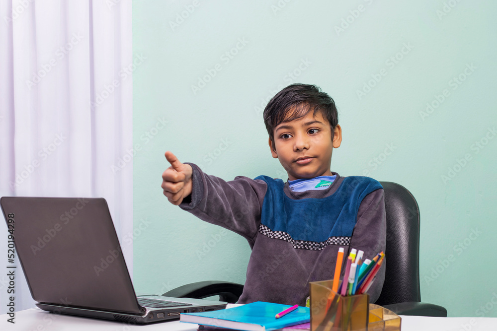 Little boys attending to online class from home. The school has been closed during coronavirus outbreak and the classes have moved to e-learning platform Little boys attending to online class from home. The school has been closed during coronavirus outbreak and the classes have moved to e-learning platform