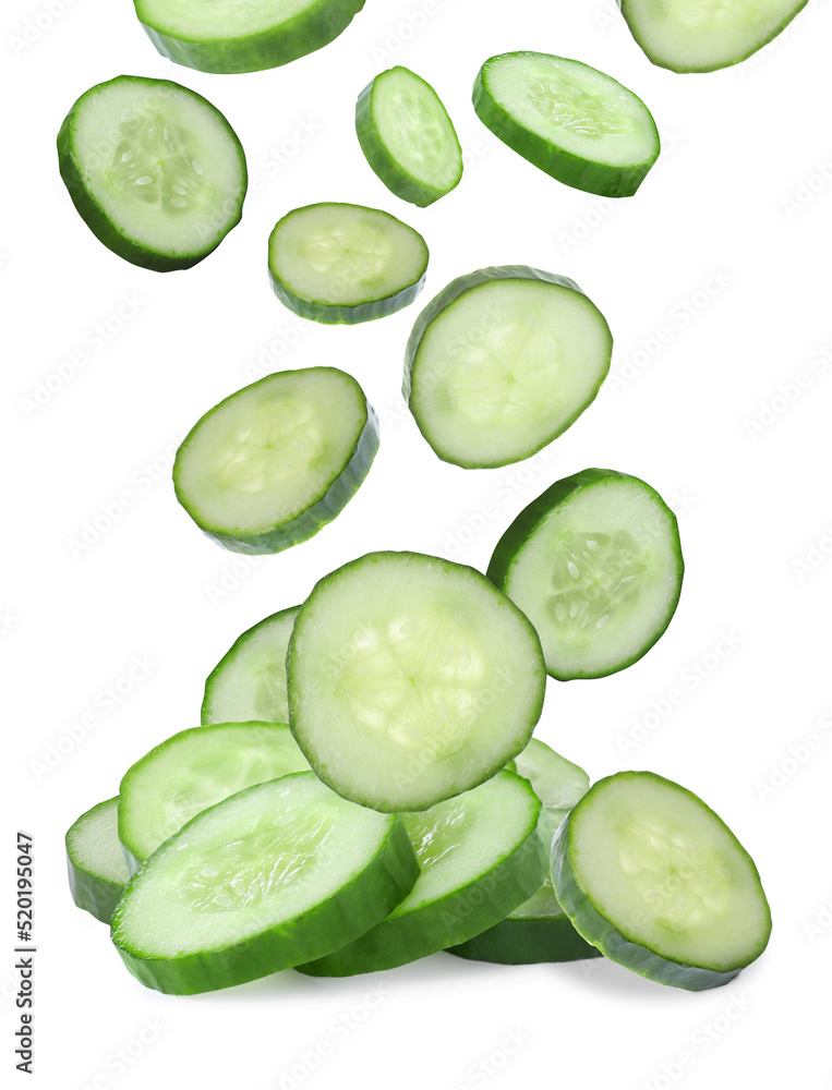 Slices of fresh green cucumbers falling on white background Slices of fresh green cucumbers falling on white background