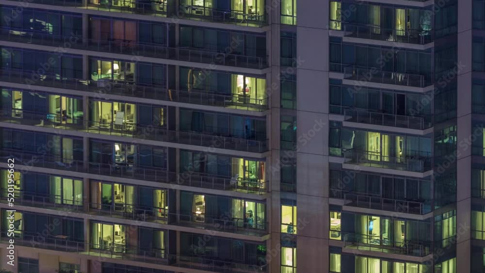 Windows lights in residential high-rise buildings timelapse at night. Multi-level skyscrapers with illuminated rooms inside Windows lights in residential high-rise buildings timelapse at night. Multi-level skyscrapers with illuminated rooms inside