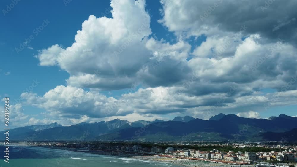 Aerial pull from the beautiful city of Viareggio on the versilian coast of Italy with dramatic cloudscape over mountains. Aerial pull from the beautiful city of Viareggio on the versilian coast of Italy with dramatic cloudscape over mountains.