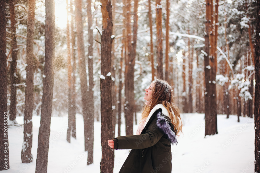 Girl woman and cat sitting on her shoulder in snowy winter forest Girl woman and cat sitting on her shoulder in snowy winter forest