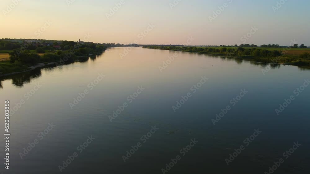 Polish Vistula River with dark water at sunset in evening. Global warming concept Polish Vistula River with dark water at sunset in evening. Global warming concept