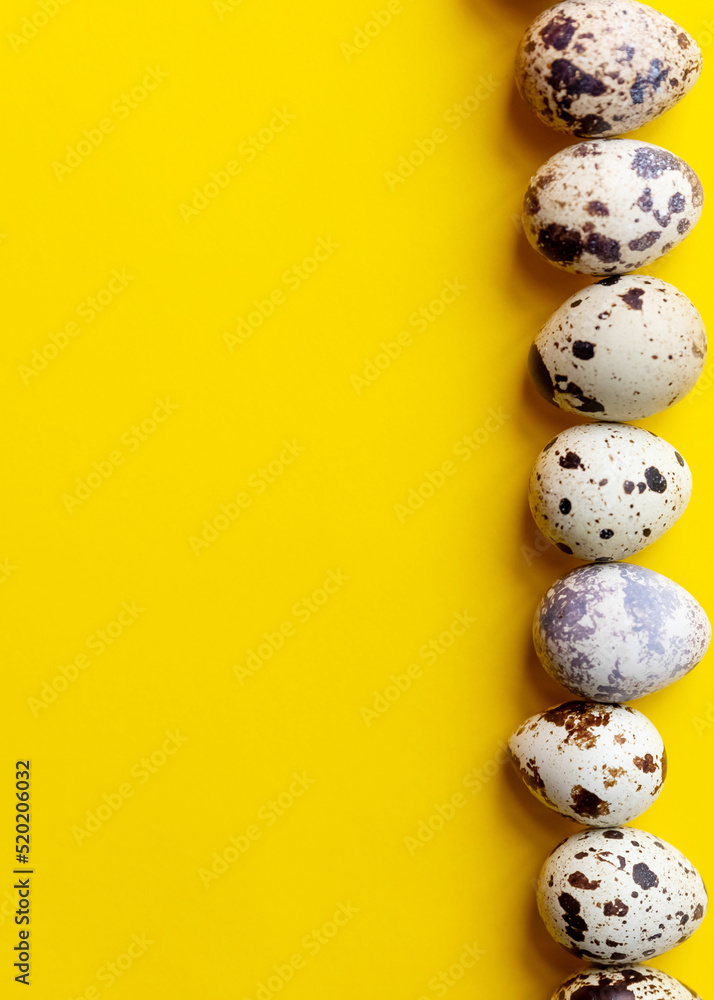 Top view ,Row of small speckled Quail eggs on yellow background. Minimal Happy Easter composition.healthy lifestyle diet concept. Copy space.organic natural egg.