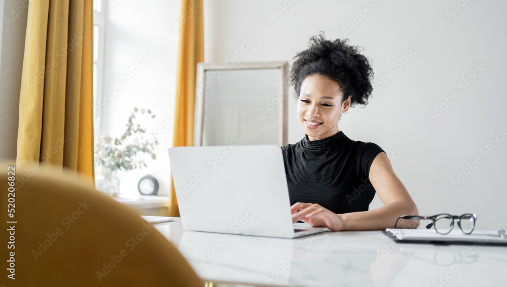 A woman manager works with documents online in the office workplace, laptop on the table, finances in the company A woman manager works with documents online in the office workplace, laptop on the table, finances in the company
