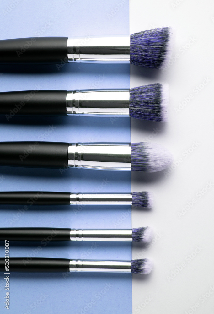 Creative concept beauty fashion photo of cosmetic product make up brushes kit on blue background. Creative concept beauty fashion photo of cosmetic product make up brushes kit on blue background.