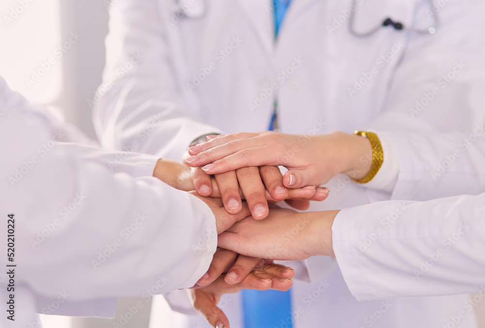 Doctors and nurses stacking hands. Isolated on white Doctors and nurses stacking hands. Isolated on white