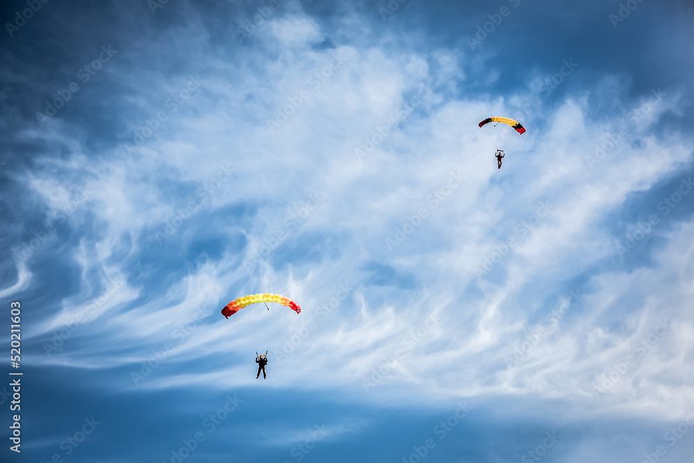Russia Moscow region Vatulino. 08.10.2018 Two colorful parachutes on blue cloudy sky. Parachute jumps. Active life style.