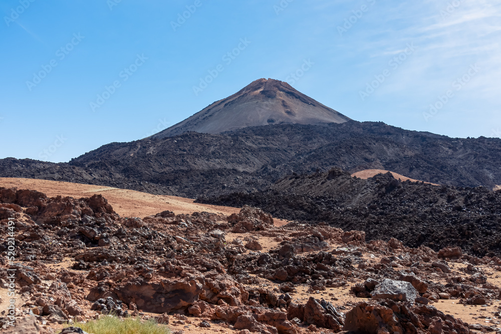 Hiking trail over volcanic desert terrain leading to summit of volcano Pico del Teide, Mount Teide National Park, Tenerife, Canary Islands, Spain, Europe. Solidified lava, ash, pumice along the way