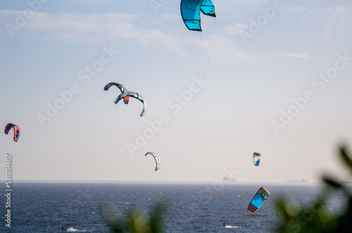 Kite surfers on a sunny day surfing on a beautiful blue ocean