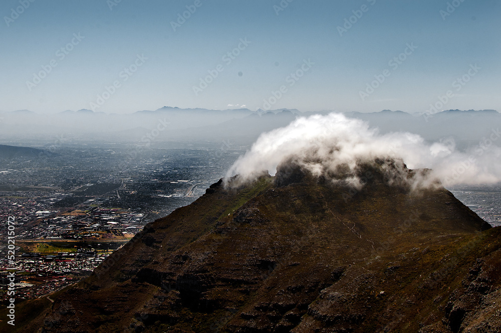 Fluffy cloud covering a mountain top Fluffy cloud covering a mountain top