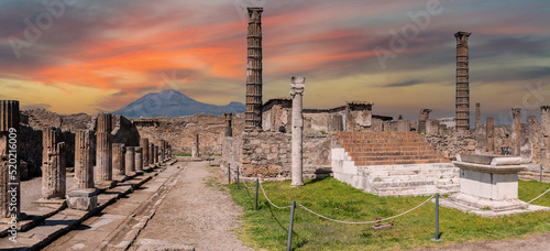 POMPEII, ITALY - MAY 04, 2022 - Colonnade and sculptures of the Temple of Apollo near the Pompeian forum, Italy photo