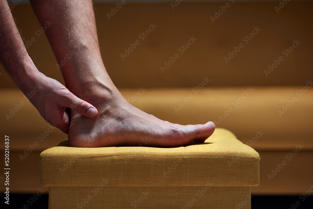 Adult male with foot pain, dislocation, numbness, cramp and other joint issues. Stock Photo