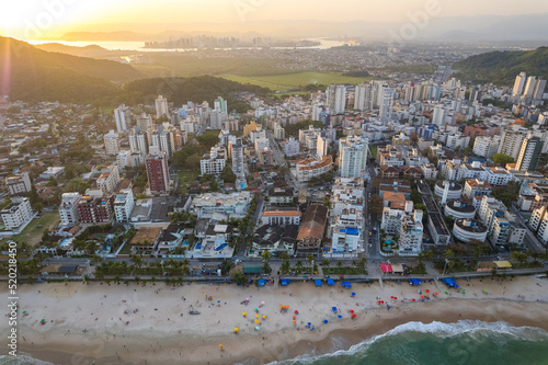 Imagem aérea da praia do Tombo, localizada na cidade do Guarujá. Ondas, natureza, montanhas e banhistas. photo