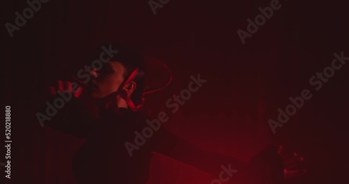 Beautiful hat dressed girl dancing latin dance . Professional female dancer dancing flamenco , rumba or salsa on red background with lines . Spanish dance movements . Shot ARRI ALEXA Cinema Camera .
