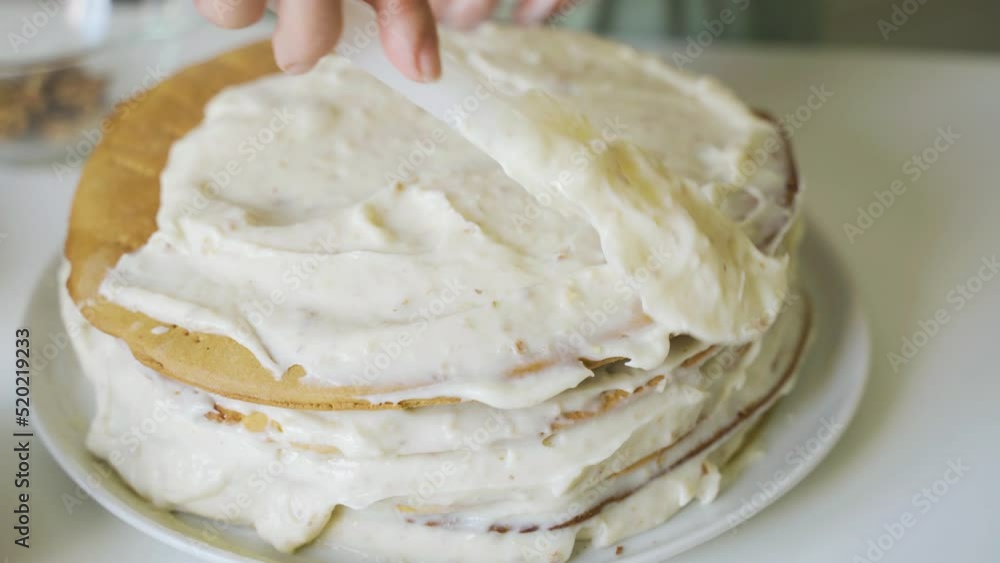 We are preparing a very simple homemade cake, smeared with sweet cream. Simple home cooking, light snack. We are preparing a very simple homemade cake, smeared with sweet cream. Simple home cooking, light snack.